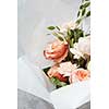 Composition of flowers of white or orange roses represented on grey background. Decoration of grey background in Valentine's Day. Holiday concept.