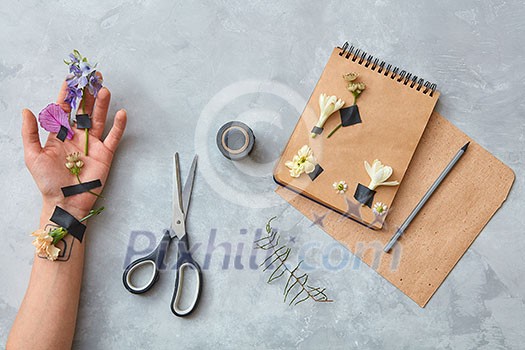 Human being's hand with flowers as decoration or designing for any post card. Human being's hand with flowers as decoration or designing for any post card.