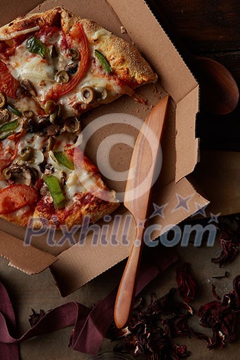 delicious italian pizza with vegetables and cardboard delivery box, flat lay