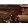 Wooden utensils for cooking and parchment paper on a wooden table