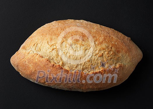 one loaf of bread close-up on a dark background one loaf of bread close-up on a dark background