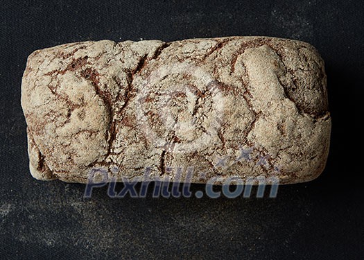 Rustic dark bread loaf isolated on black background Rustic dark bread loaf isolated on black background
