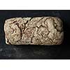 Rustic dark bread loaf isolated on black background