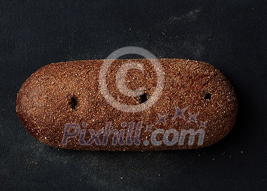 single whole full rye dark bread isolated on black background single whole full rye dark bread isolated on black background