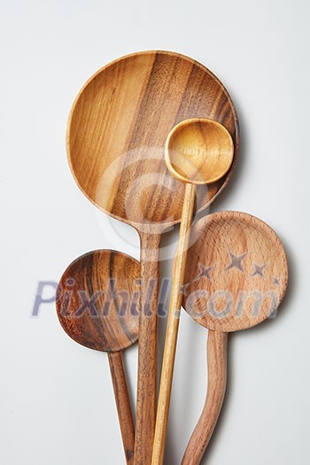 different kitchen wooden utensils on a white background on a white background