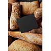 Baking and cooking concept background. Top view with copy space on black wooden table. Border of different bread sorts.