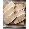 Sandwich with sliced cheese over white cooking paper. Sandwich for having snack or bread during your work.