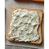 Sandwich with cream sauce over white cooking paper. Sandwich for having snack or bread during your work.