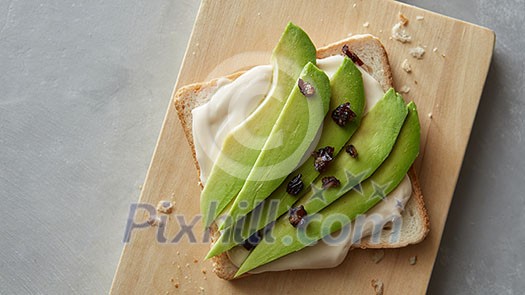 fresh sandwich with avocado on a wooden board