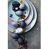 Three plates of different sizes with Easter eggs and petals on a stone background