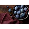 copper pan with eggs and wooden spoon on old wooden background with apron, flat lay