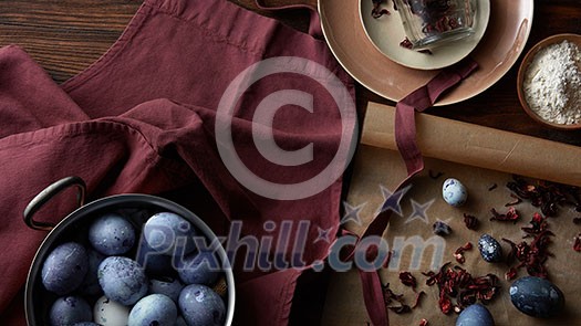 Utensils for preparing and colored eggs on rustic table, flat lay Utensils for preparing and colored eggs on rustic table, flat lay