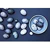 Easter eggs on blue plate on a blue background, flat lay