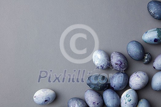 Blue eggs in a corner on a blue background