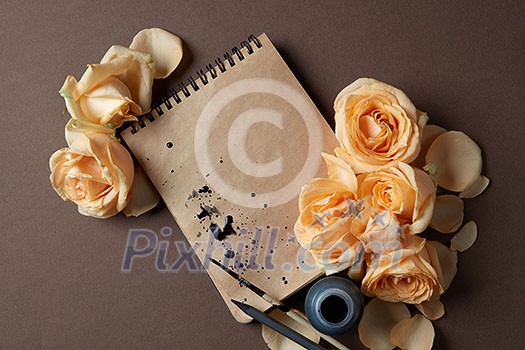 Diary or notebook with yellow roses around for ideas and expressing emotions. Blank copy space for writing congratulations. Women's Day concept. Valentine's Day concept.