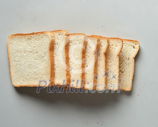 Fresh toasts of bread for sandwiches over light grey background Fresh toasts of bread for sandwiches over light grey background