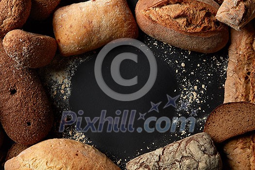 Fresh bread in round frame with copy space over black