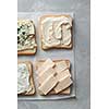 Various types of cheese on toasts close up