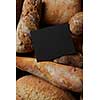 Top view of frame copy space of black color represented among different kinds of bread. Border of different bread sorts. Baking and cooking concept background.