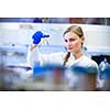 Portrait of a female researcher carrying out research in a chemistry lab (color toned image; shallow DOF)