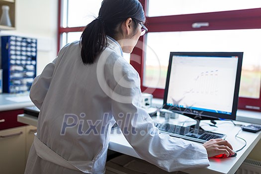 Portrait of a female researcher carrying out research in the lab (color toned image; shallow DOF)