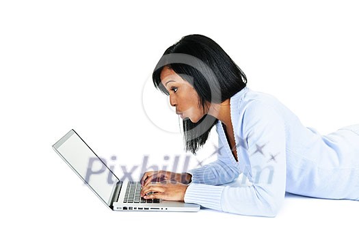 Surprised black woman laying with computer isolated on white background