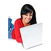 Smiling black woman typing on computer laying on floor