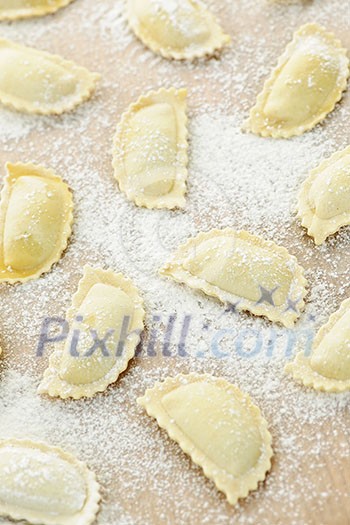 Uncooked ravioli pasta prepared and ready for cooking from above Uncooked ravioli pasta prepared and ready for cooking from above