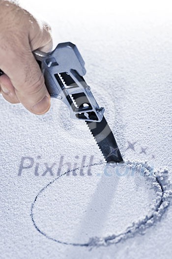 Handsaw cutting circular hole in ceiling tile Handsaw cutting circular hole in ceiling tile