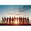 Silhouette of business people of different professions on sunset background