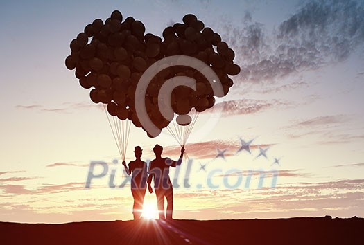 Silhouettes of guy and girl representing love and affection on sunset background