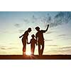 Silhouettes of happy family of three people mother father and child