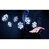 Close view of businessman in suit holding dollar sign in palm