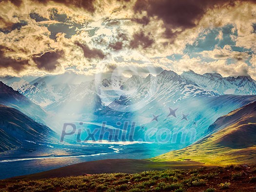 Vintage retro effect filtered hipster style image of Himalayan valley landscape with Himalayas mountains. Sun rays come through clouds. Himachal Pradesh, India