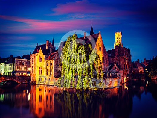 Famous view of Bruges- vintage retro effect filtered hipster style image of Belfry and old houses along canal with tree. Brugge, Belgium Famous view of Bruges- vintage retro effect filtered hipster style image of Belfry and old houses along canal with tree. Brugge, Belgium