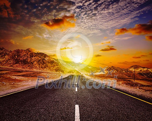Travel forward concept background - vintage retro effect filtered hipster style image of road in Himalayas with mountains and dramatic clouds on sunset. Ladakh, Jammu and Kashmir, India Travel forward concept background - vintage retro effect filtered hipster style image of road in Himalayas with mountains and dramatic clouds on sunset. Ladakh, Jammu and Kashmir, India