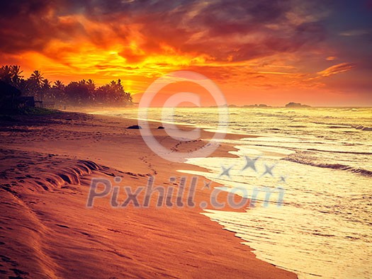 Beach holidays vacation romantic concept background - vintage retro effect filtered hipster style image of tropical sunset on ocean beach. Hikkaduwa,  Sri Lanka