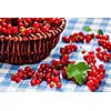 Redcurrant red currant berries in wicker bowl on kitchen table