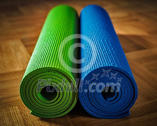 Yoga concept background - yoga mats on wooden floor Yoga concept background - yoga mats on wooden floor
