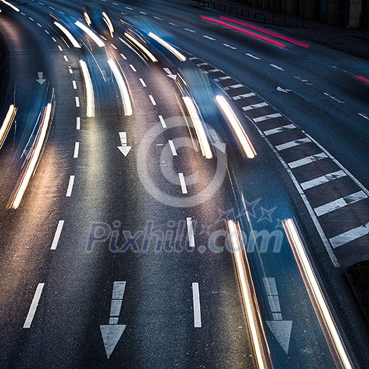 Motion blurred city road traffic (color toned  image)