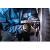 mechanic changing a wheel of a modern car (color toned image)