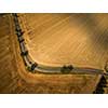 Aerial view of a tractor working a field after harvest