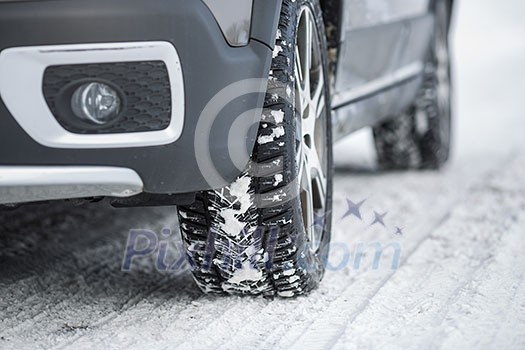 Car with winter tires on a slippery, snowy road