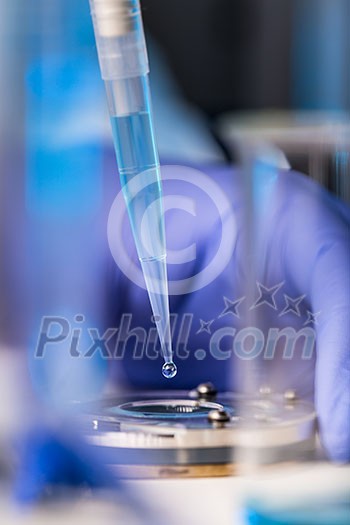 Hands of a researcher carrying out scientific research in a lab