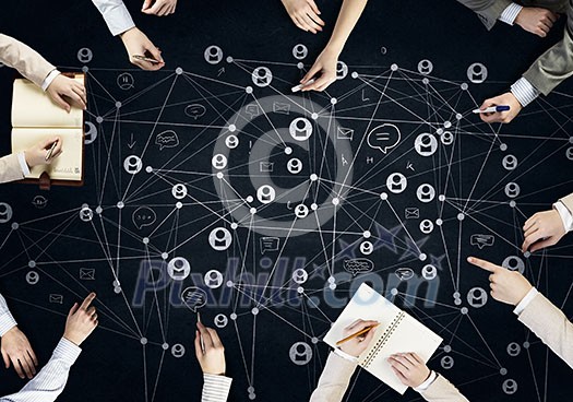Top view of people hands drawing networking strategy Top view of people hands drawing networking strategy