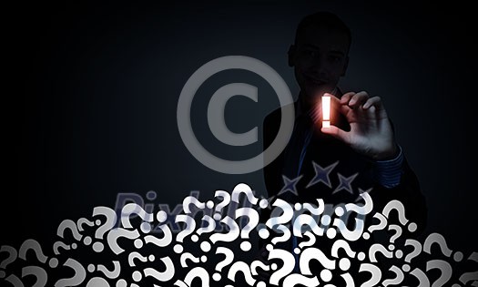 Young businessman on dark background taking exclamation mark with fingers Young businessman on dark background taking exclamation mark with fingers