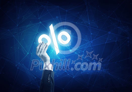 Businessman hand on connection background holding glowing discount symbol Businessman hand on connection background holding glowing discount symbol