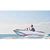 Young woman riding on drawn sailing boat on sea waves