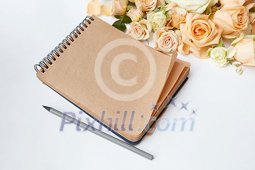 note pad with pen and beautiful bouquet on a white background ,