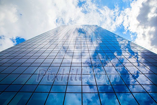 modern office building with glass front and sky reflection